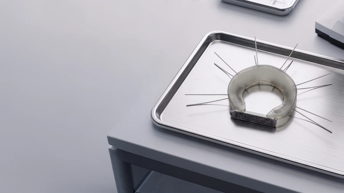 A LunaFlex implant on a stainless steel instrument tray in a laboratory.